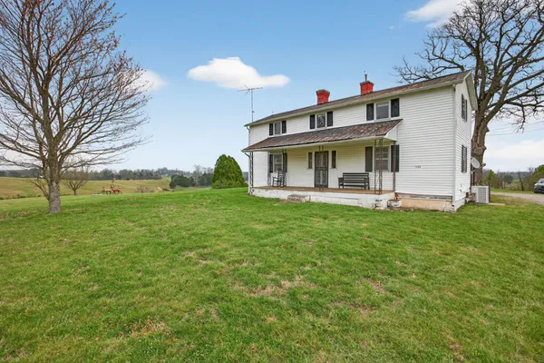 a front view of house with yard and green space