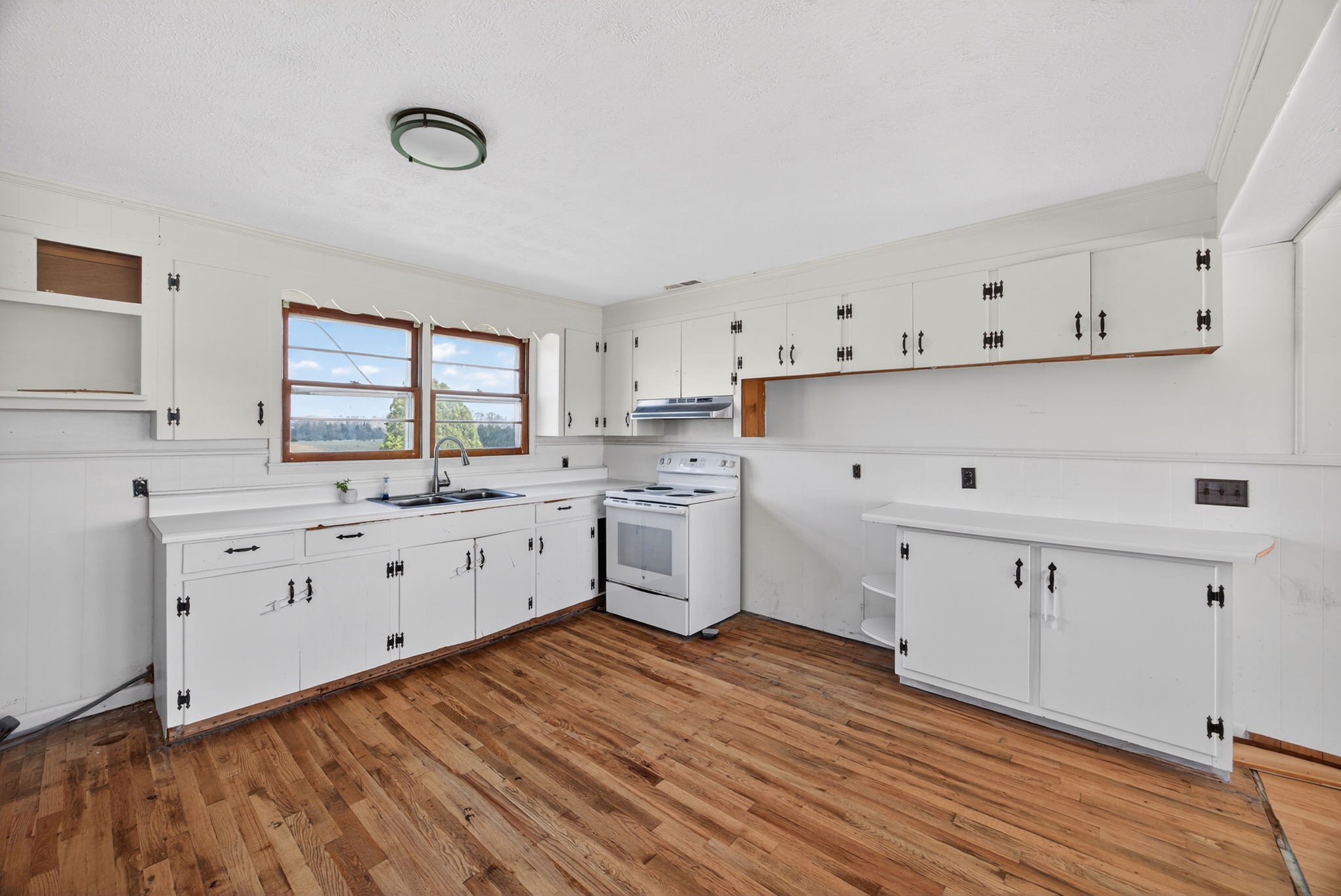 1298 South Bunker Hill Road Sparta, TN 38583 - Photo 5 of 35 a kitchen with cabinets wooden floor and a window