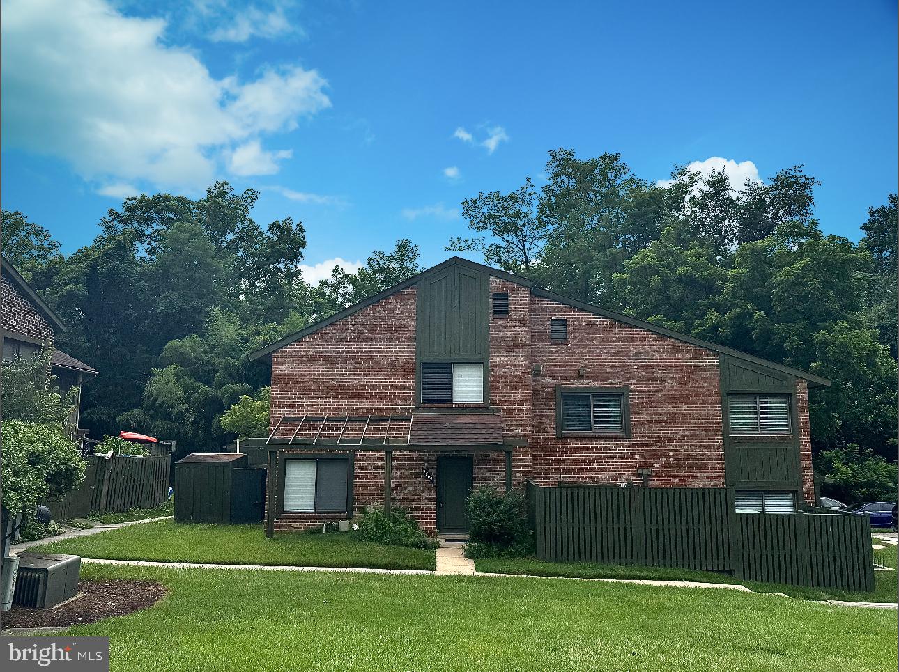 a front view of a house with a garden and yard