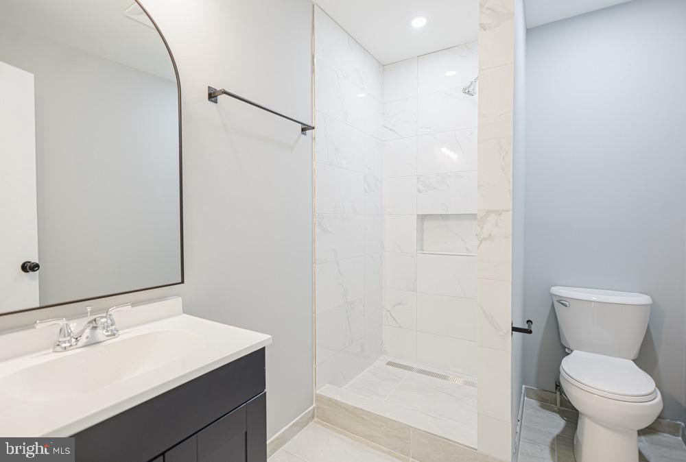 5764 Thunder Hill Road Columbia, MD 21045 - Photo 14 of 16 a bathroom with a sink toilet and shower