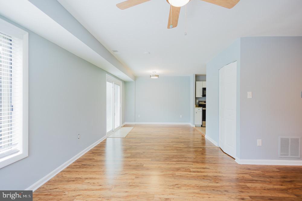 5764 Thunder Hill Road Columbia, MD 21045 - Photo 3 of 16 a view of an empty room with wooden floor and a window