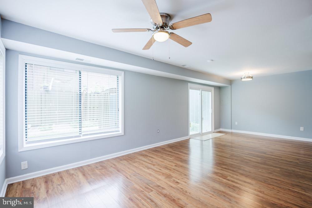 5764 Thunder Hill Road Columbia, MD 21045 - Photo 4 of 16 an empty room with wooden floor and windows