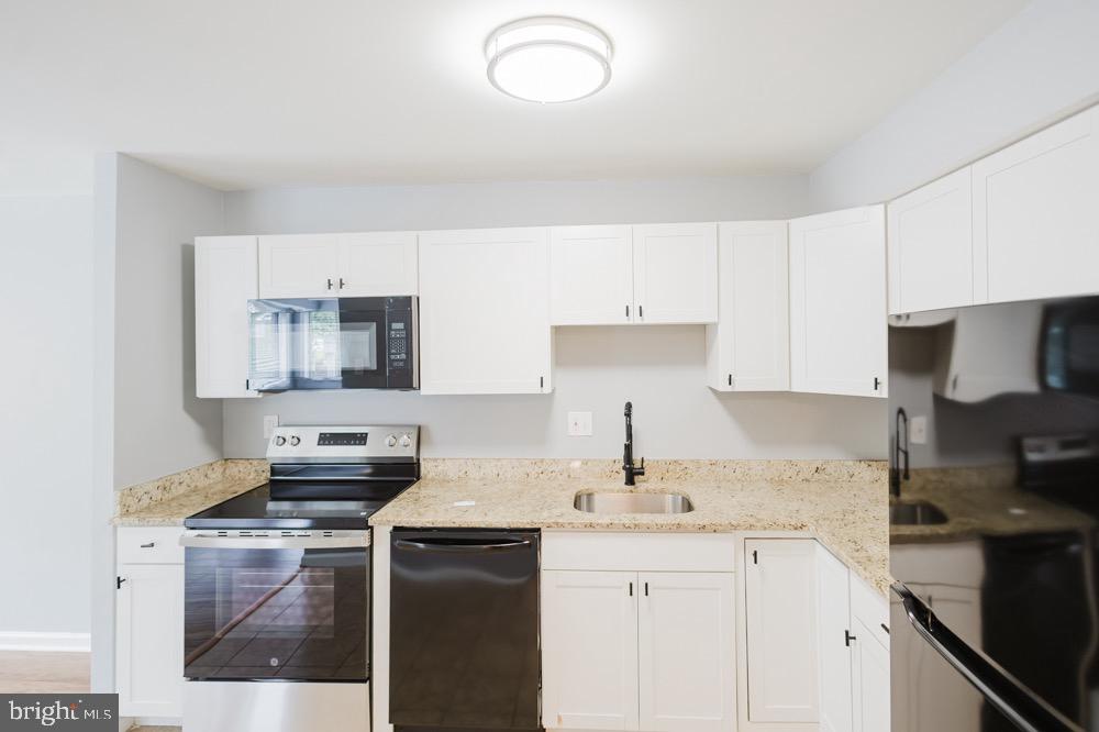 5764 Thunder Hill Road Columbia, MD 21045 - Photo 7 of 16 a kitchen with a sink stove and cabinets