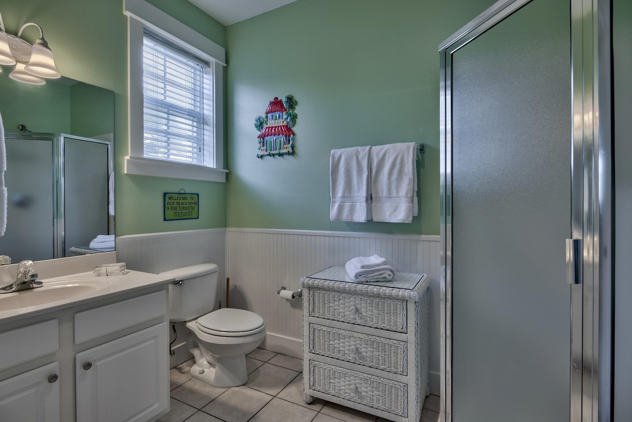 8335 County 30a Hwy Inlet Beach, Unit 5 Inlet Beach, FL 32461 - Photo 23 of 33 a bathroom with a granite countertop toilet sink and mirror
