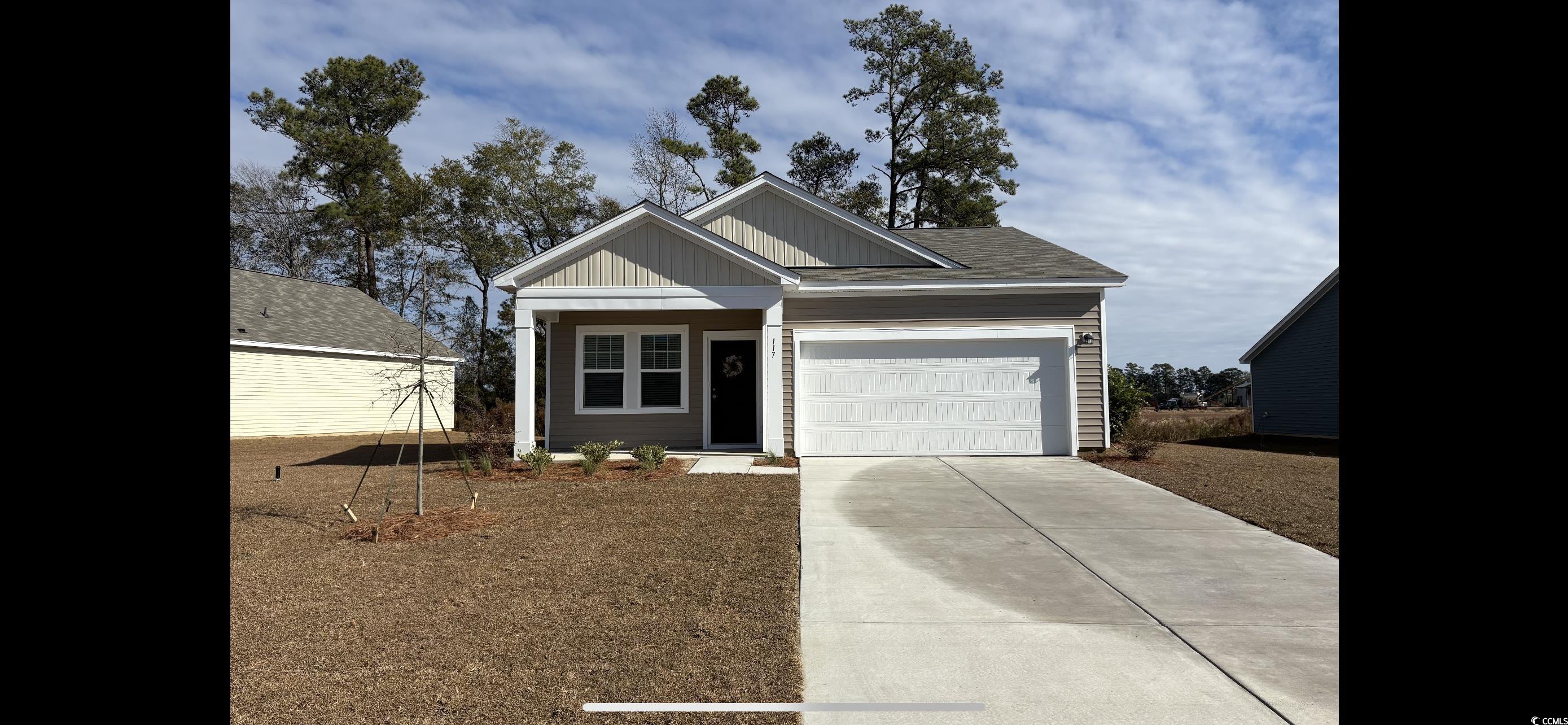 View of front of house featuring driveway, an attached garage, and board and batten siding