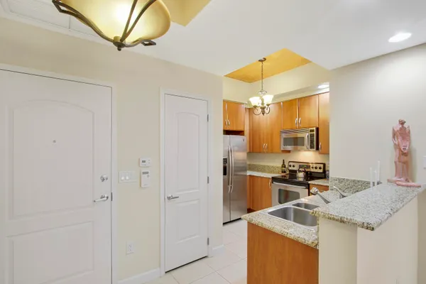 a kitchen that has a sink and a stove in it