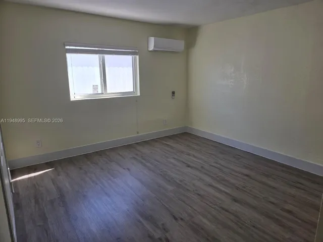 a bathroom with a granite countertop toilet sink and mirror