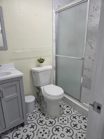 a bathroom with a sink toilet and mirror