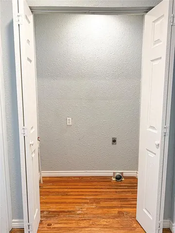 a view of a room with wooden floor and white walls