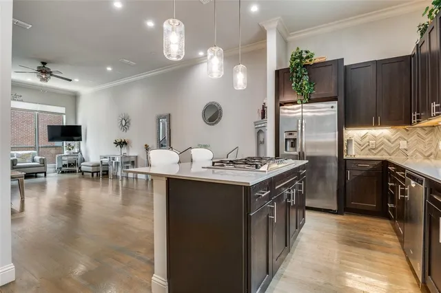 a kitchen with sink stove and refrigerator