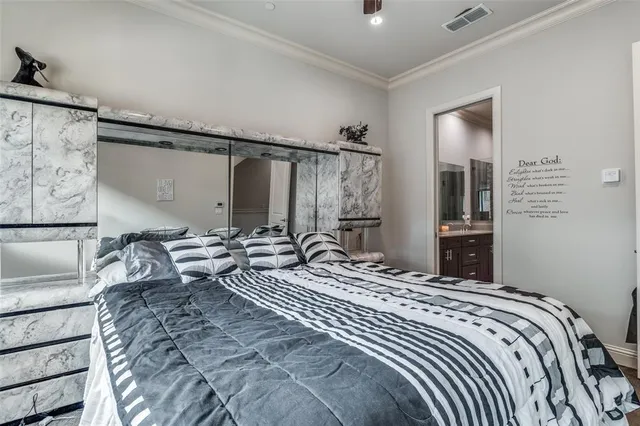 a bedroom with a large bed and a chandelier