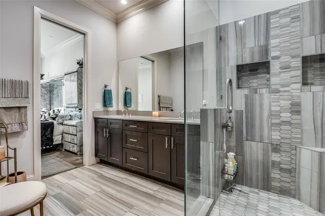 a spacious bathroom with a double vanity sink a mirror and a shower