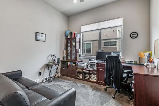 a view of a livingroom with workspace and a window