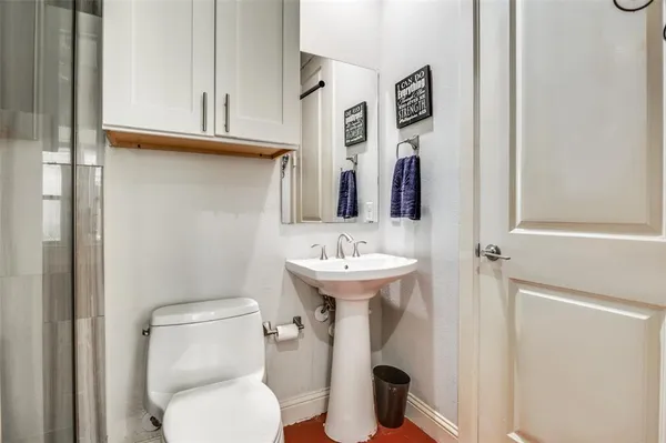 a bathroom with a toilet sink and mirror
