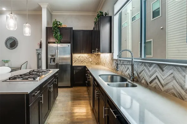 a kitchen with kitchen island stainless steel appliances a sink stove and refrigerator
