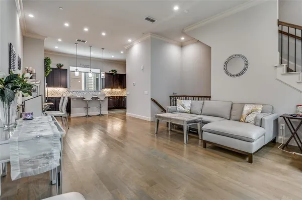 a living room with furniture and kitchen view