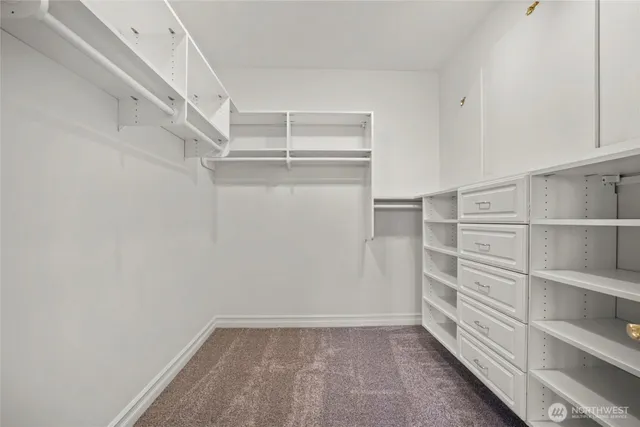 a view of walk in closet with empty racks