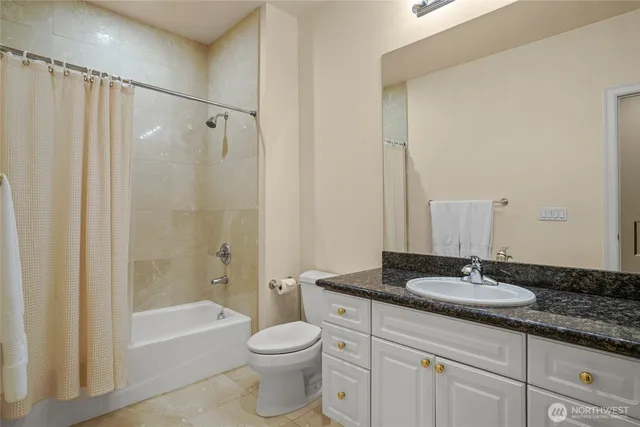 an empty room with cabinet and mirrors