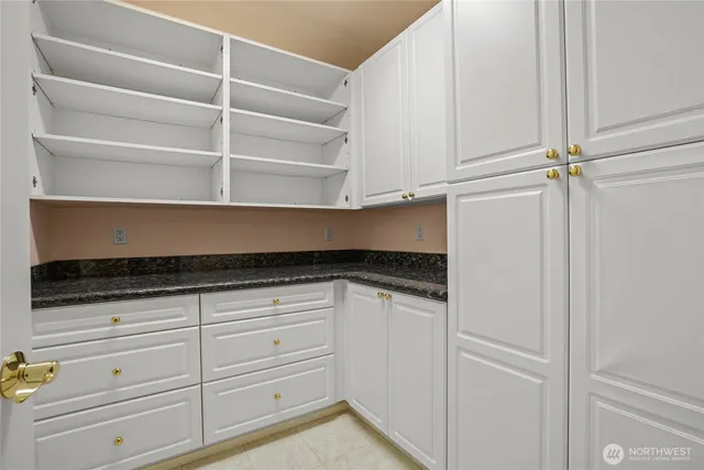a kitchen with a cabinets and white appliances