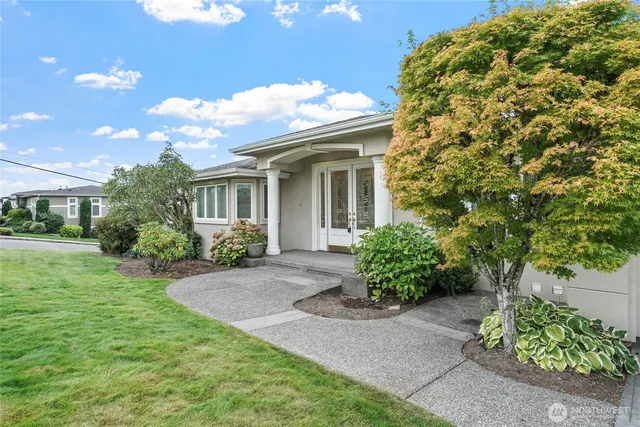 a front view of a house with garden