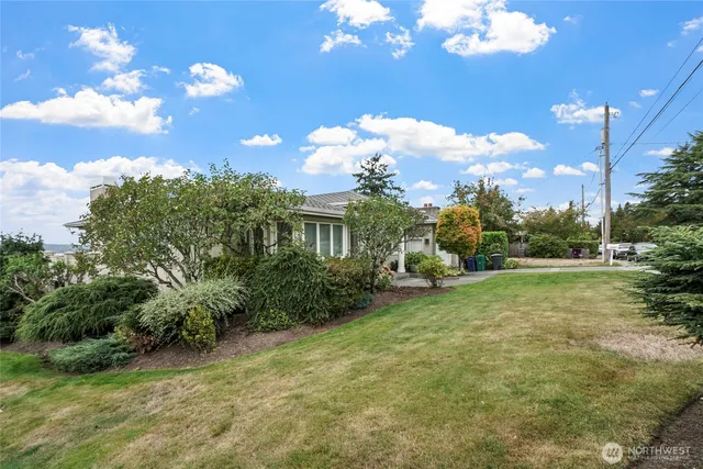 a view of a house with a chairs in a yard