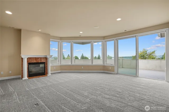 a view of an empty room with a fireplace and a large window