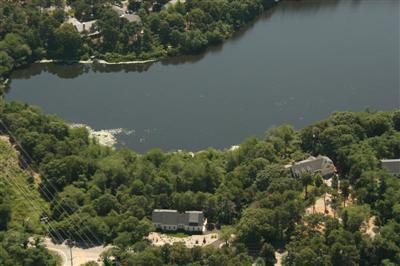 700 Satucket Road Brewster, MA 02631 - Photo 2 of 9 an aerial view of ocean with residential house with outdoor space and trees around