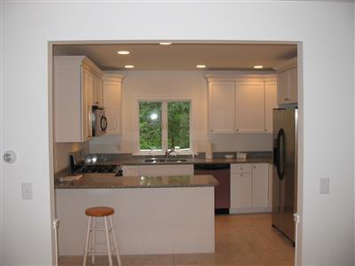 700 Satucket Road Brewster, MA 02631 - Photo 4 of 9 a kitchen with kitchen island granite countertop a sink and a stove top oven