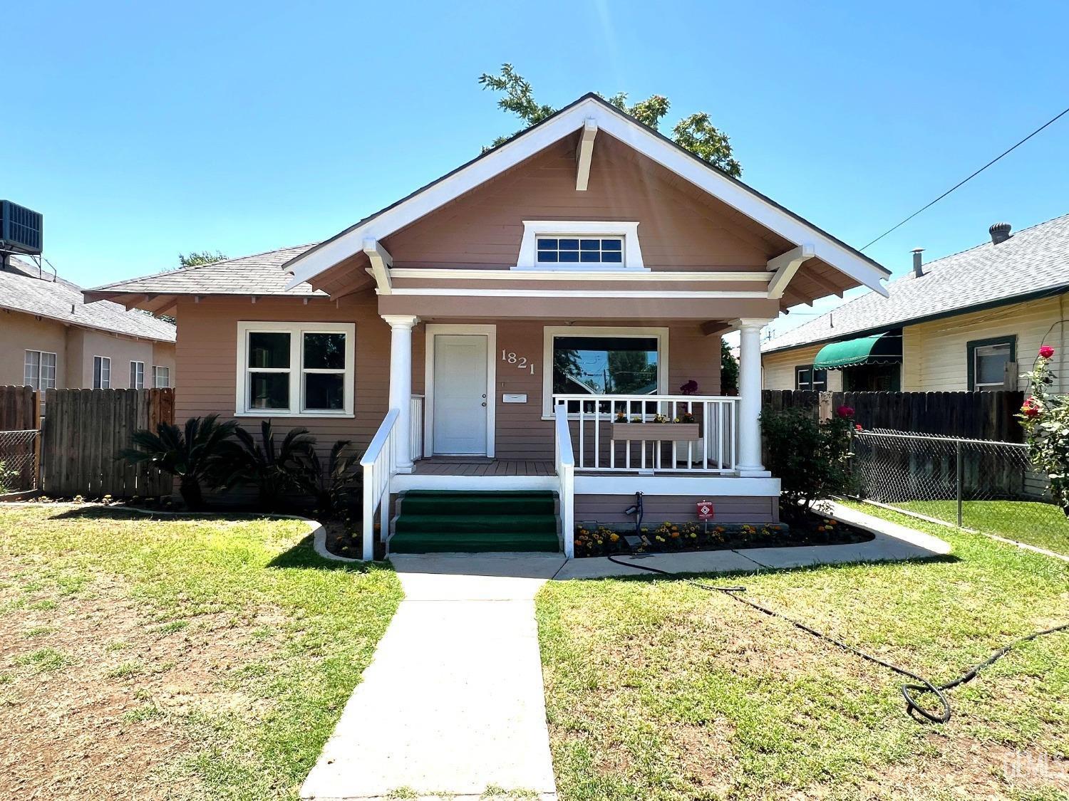 a front view of a house with a yard table and chairs