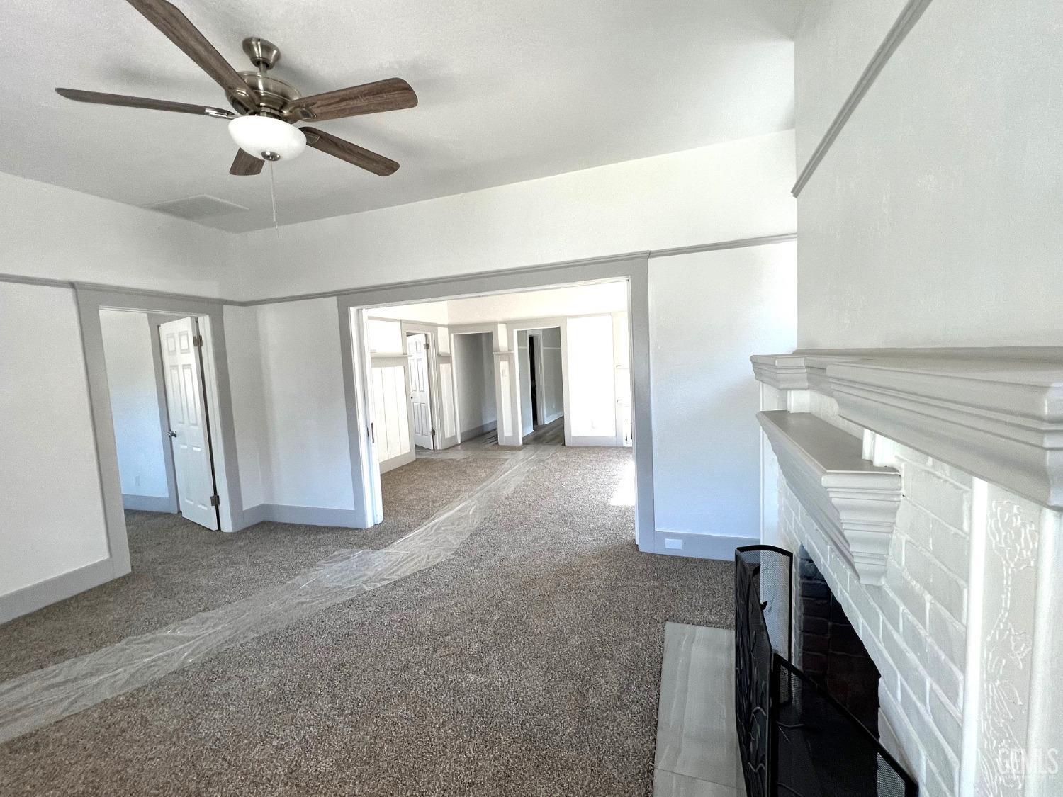 Undisclosed Address Bakersfield, CA 93304 - Photo 12 of 38 a view of an empty room with a ceiling fan