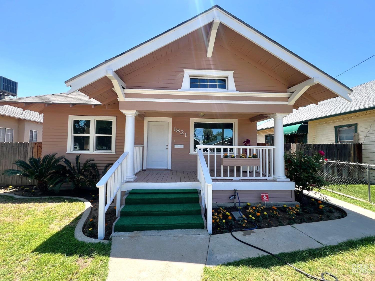 Undisclosed Address Bakersfield, CA 93304 - Photo 2 of 38 a front view of a house with garden