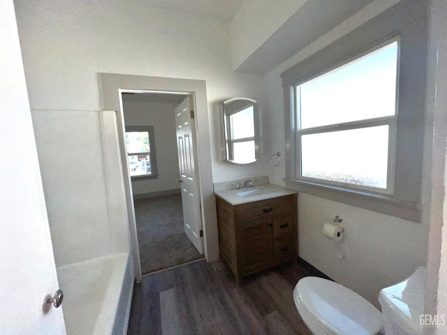 Undisclosed Address Bakersfield, CA 93304 - Photo 21 of 38 a bathroom with a toilet a sink and a mirror