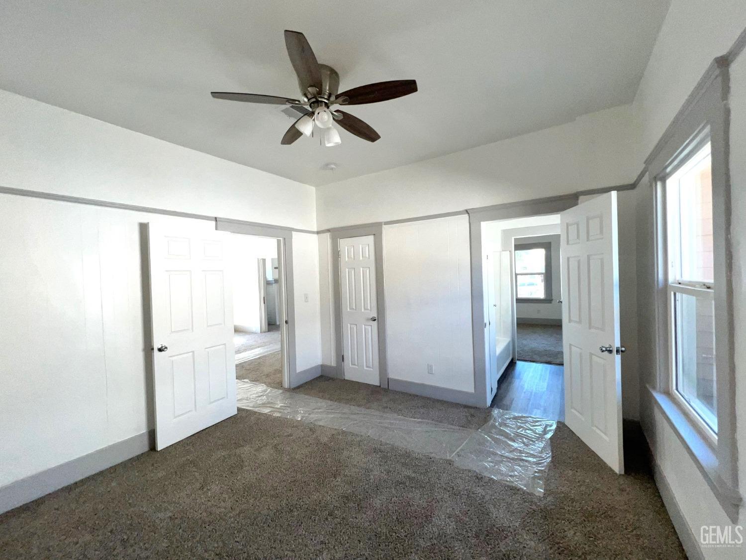 Undisclosed Address Bakersfield, CA 93304 - Photo 26 of 38 a view of empty room with wooden floor and fan