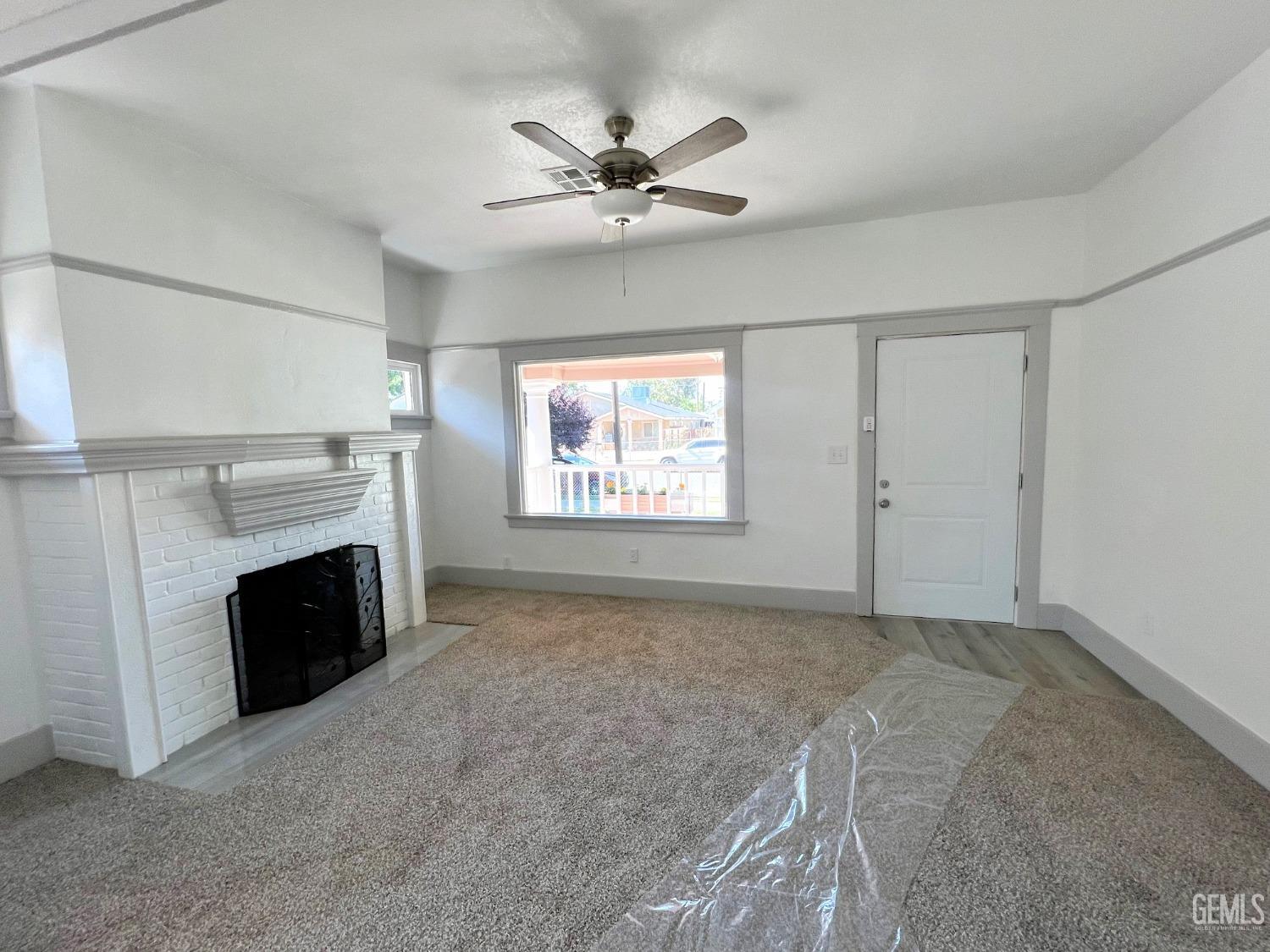 Undisclosed Address Bakersfield, CA 93304 - Photo 8 of 38 a view of a livingroom with a ceiling fan and fireplace