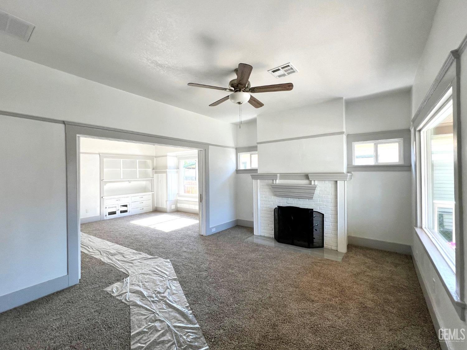 Undisclosed Address Bakersfield, CA 93304 - Photo 9 of 38 a view of a livingroom with a fireplace and window