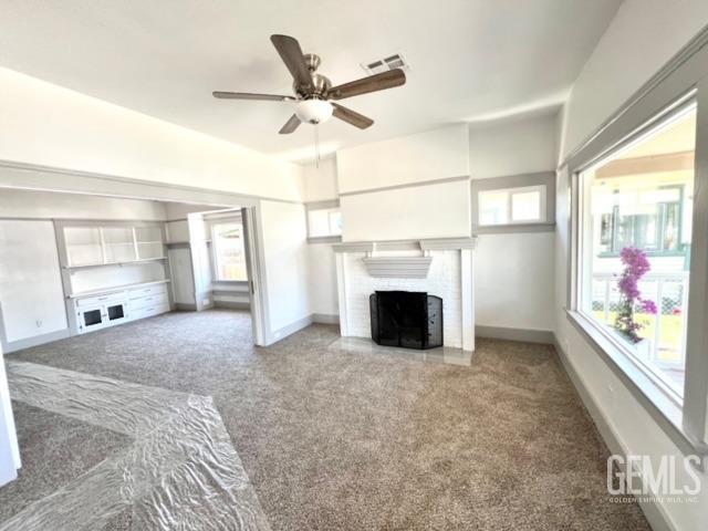 Undisclosed Address Bakersfield, CA 93304 - Photo 10 of 38 a view of empty room with fireplace and fan