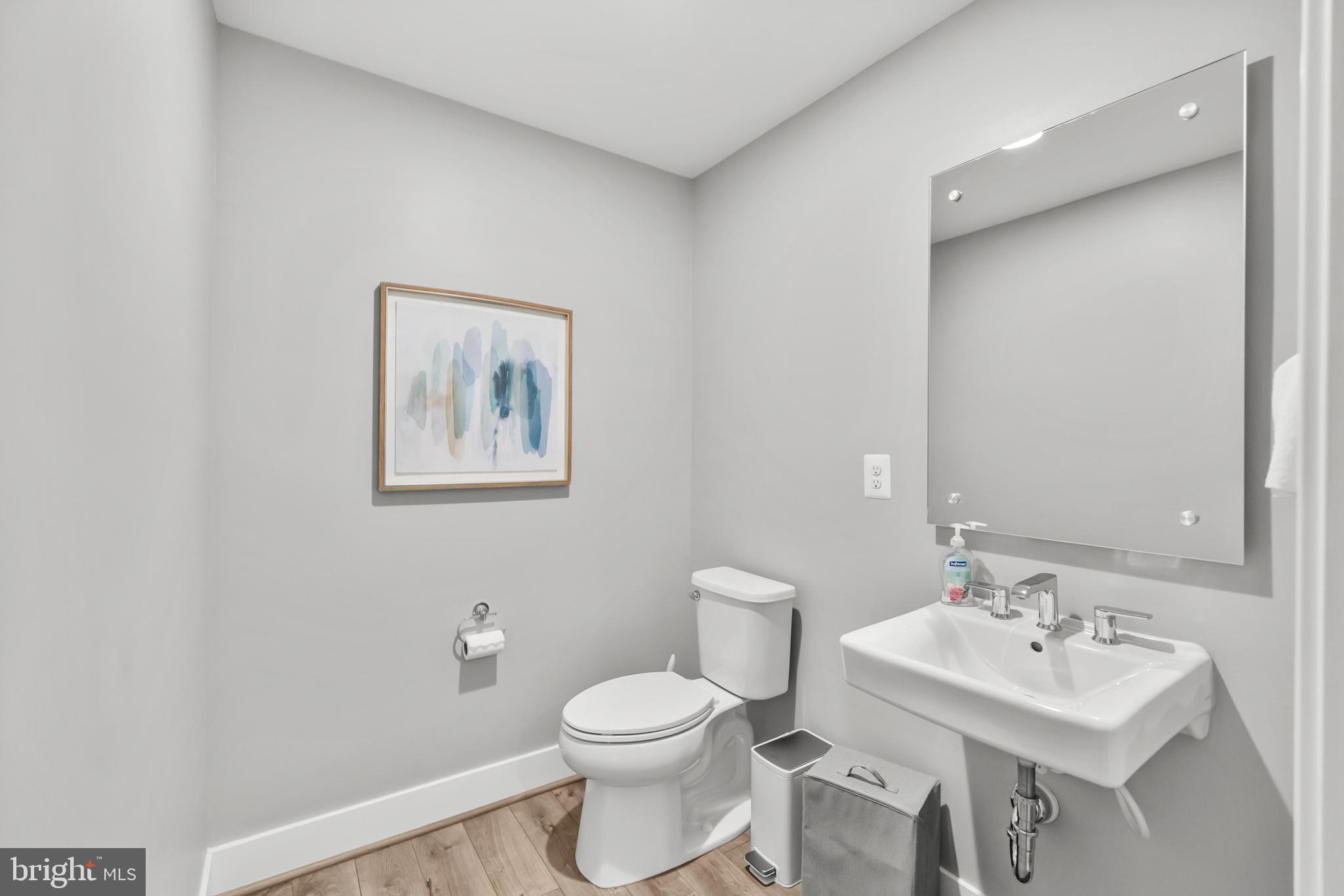 11226 Beaker Street Reston, VA 20190 - Photo 19 of 53 a bathroom with a toilet a sink and mirror