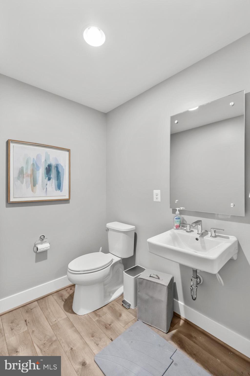 11226 Beaker Street Reston, VA 20190 - Photo 20 of 53 a bathroom with a sink a toilet and a mirror