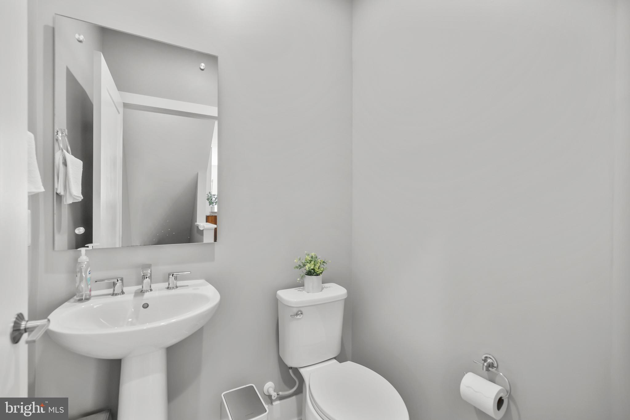 11226 Beaker Street Reston, VA 20190 - Photo 22 of 53 a bathroom with a sink mirror and toilet