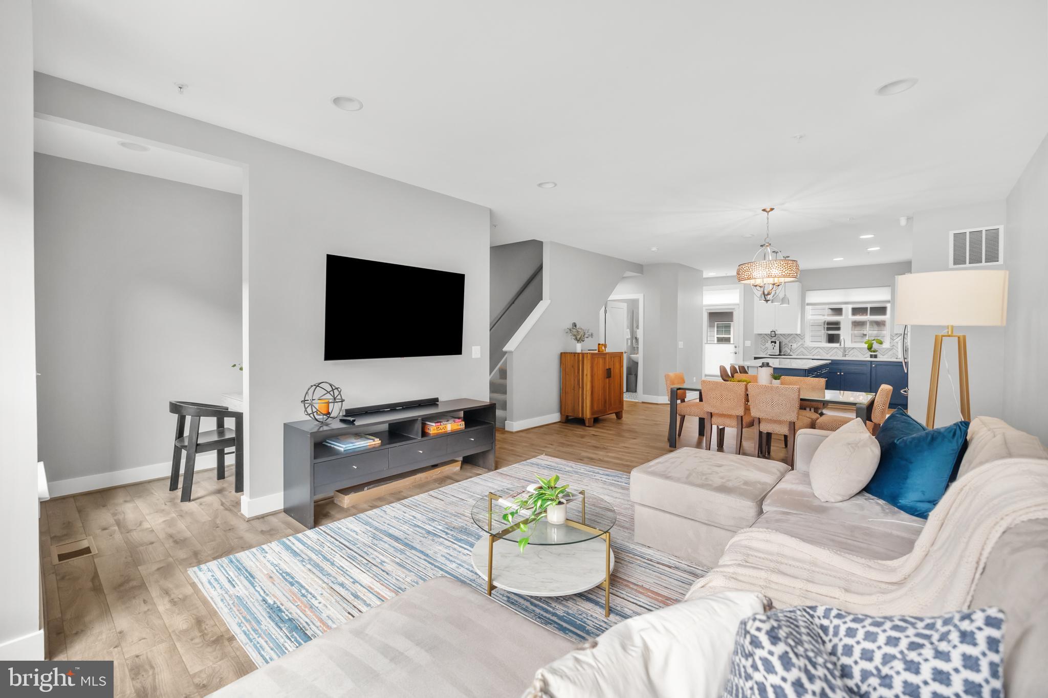 11226 Beaker Street Reston, VA 20190 - Photo 24 of 53 a living room with furniture and a flat screen tv