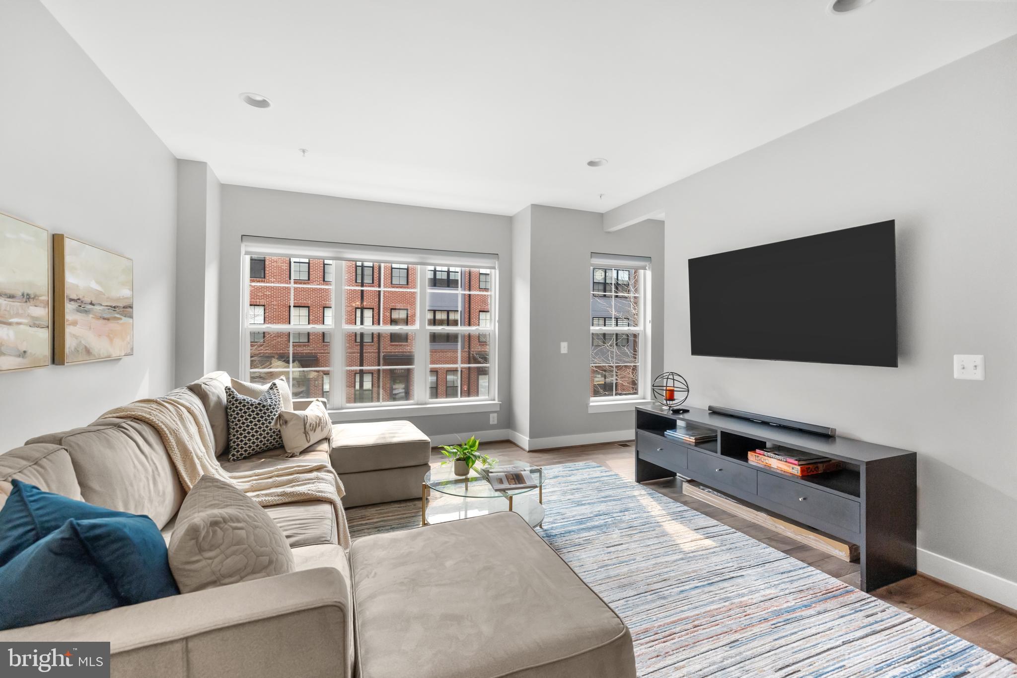 11226 Beaker Street Reston, VA 20190 - Photo 26 of 53 a living room with furniture and a flat screen tv