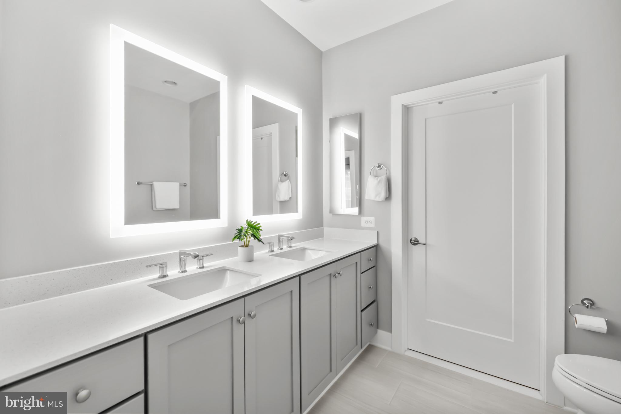 11226 Beaker Street Reston, VA 20190 - Photo 30 of 53 a bathroom with a granite countertop sink and a mirror