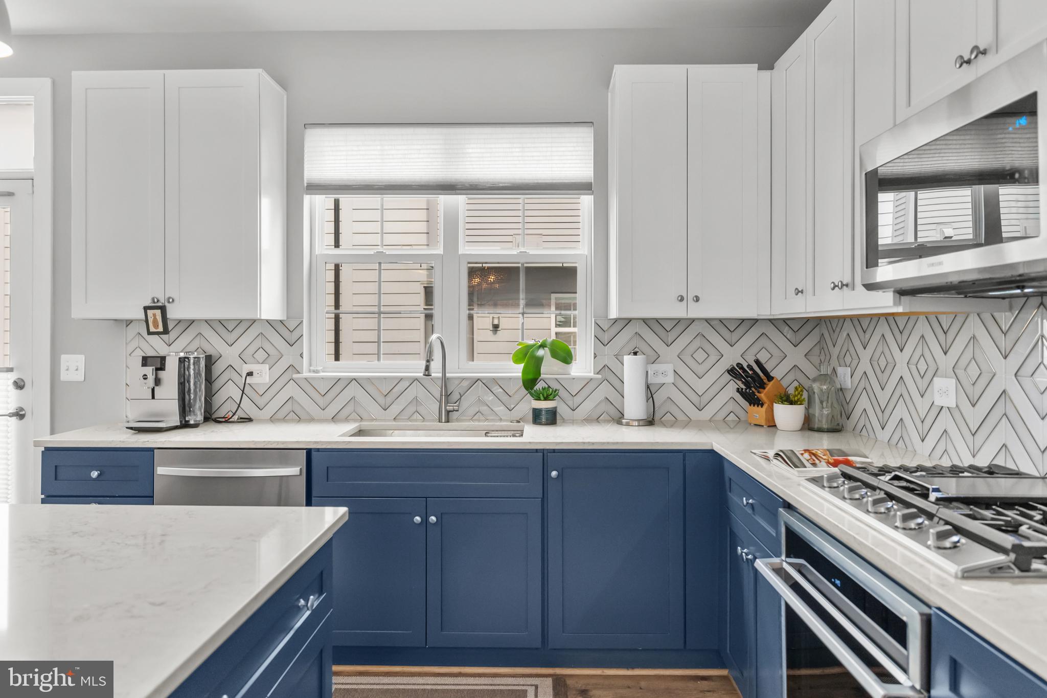 11226 Beaker Street Reston, VA 20190 - Photo 3 of 53 a kitchen with granite countertop a sink a stove and cabinets