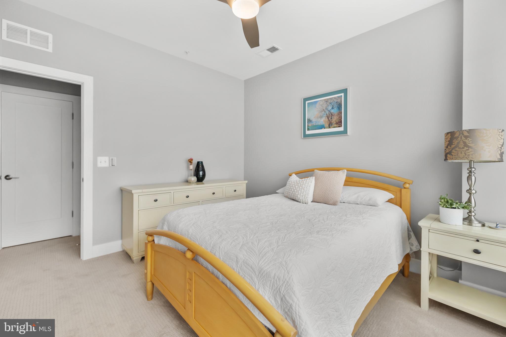 11226 Beaker Street Reston, VA 20190 - Photo 32 of 53 a bed room with a bed and a lamp