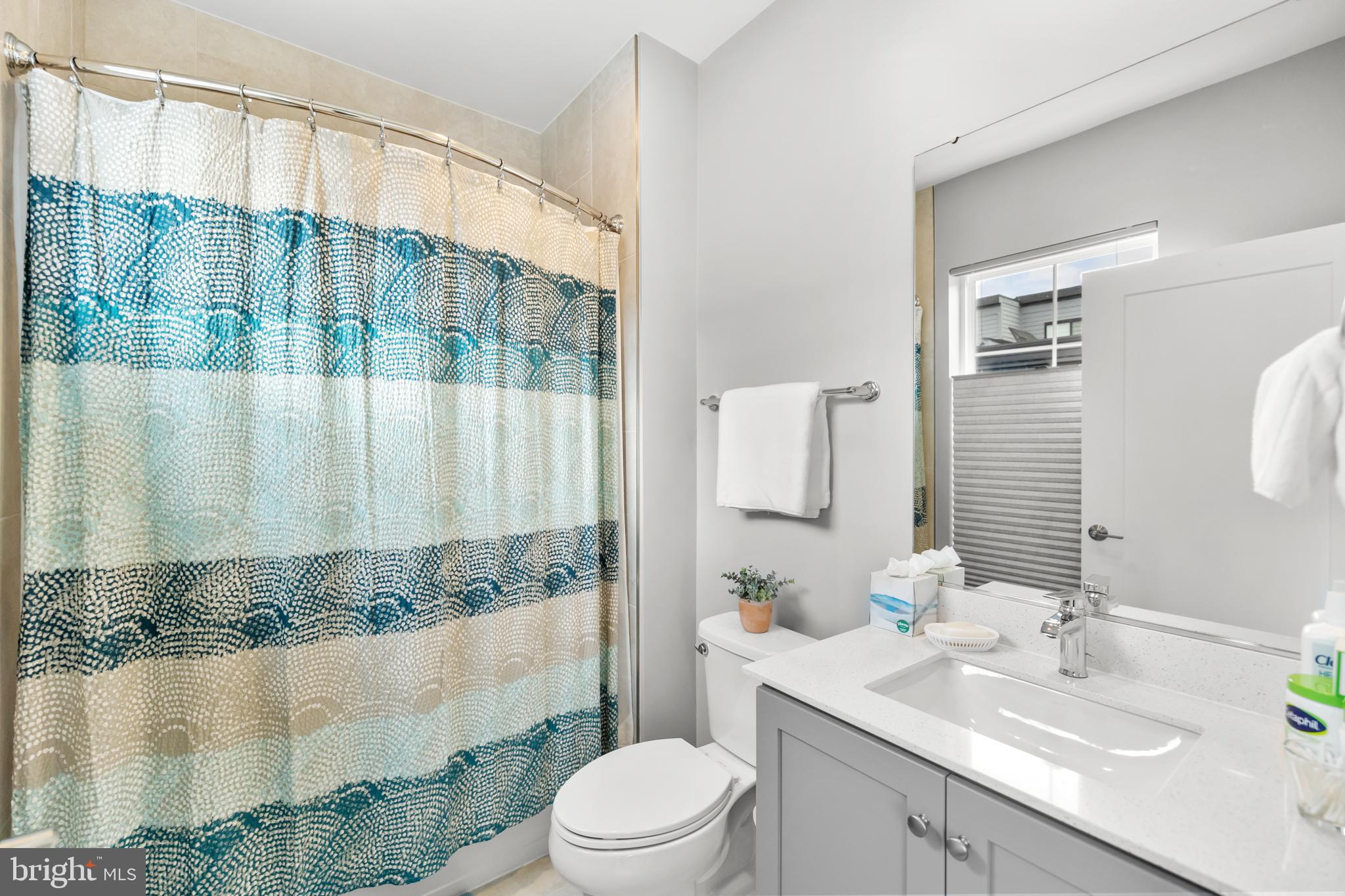 11226 Beaker Street Reston, VA 20190 - Photo 33 of 53 a bathroom with a sink a toilet and shower