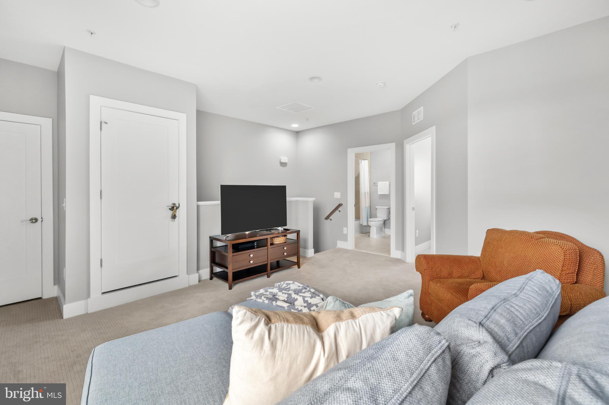 11226 Beaker Street Reston, VA 20190 - Photo 36 of 53 a living room with furniture and a flat screen tv