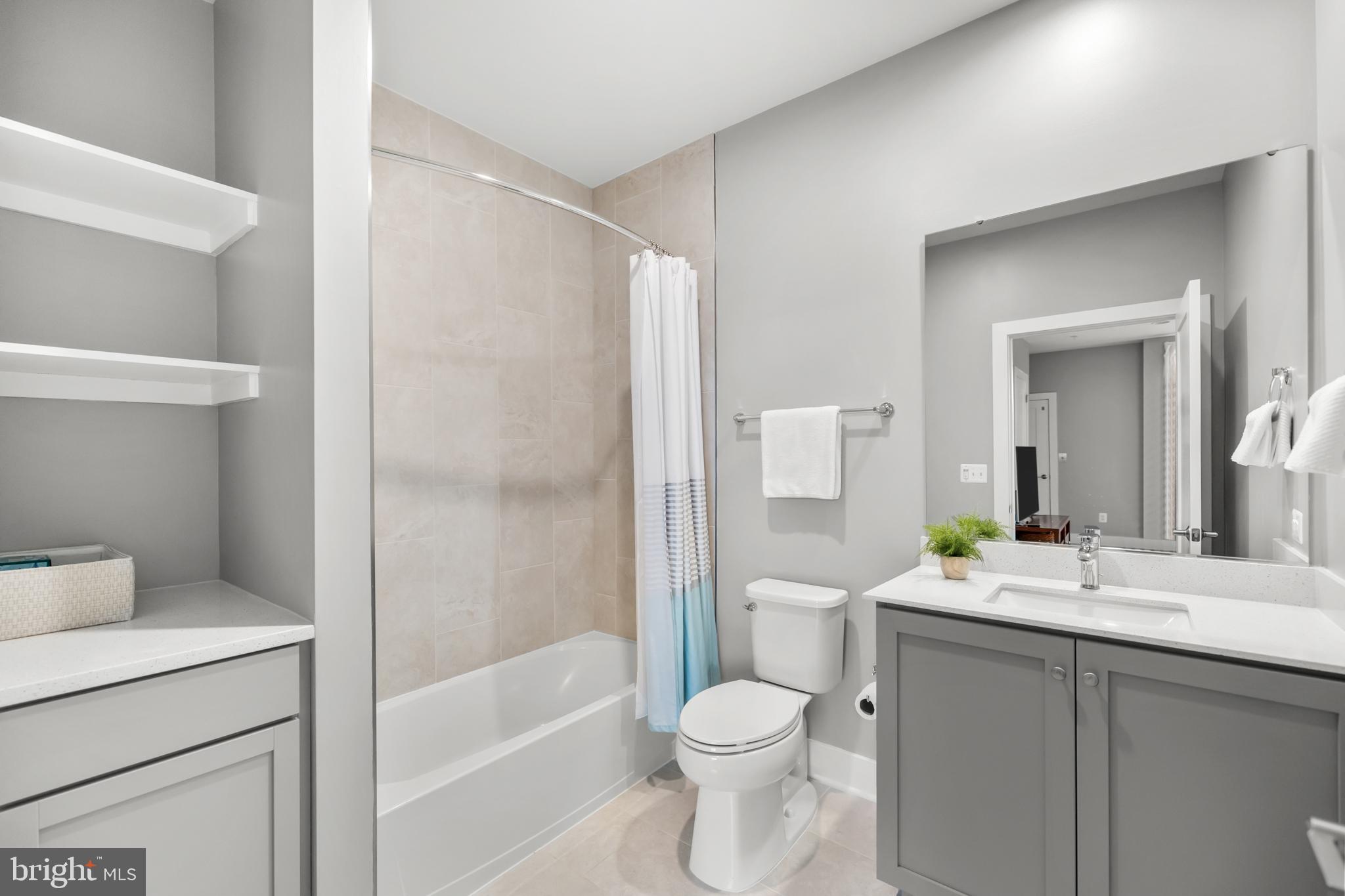 11226 Beaker Street Reston, VA 20190 - Photo 37 of 53 a bathroom with a granite countertop sink toilet and shower