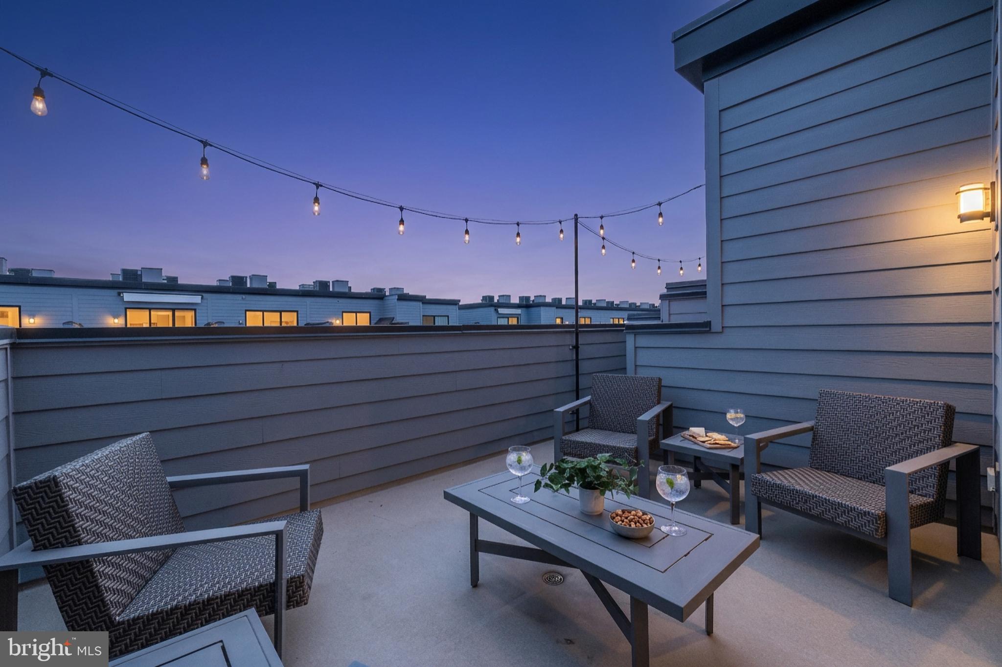 11226 Beaker Street Reston, VA 20190 - Photo 6 of 53 a roof deck with a table and chairs