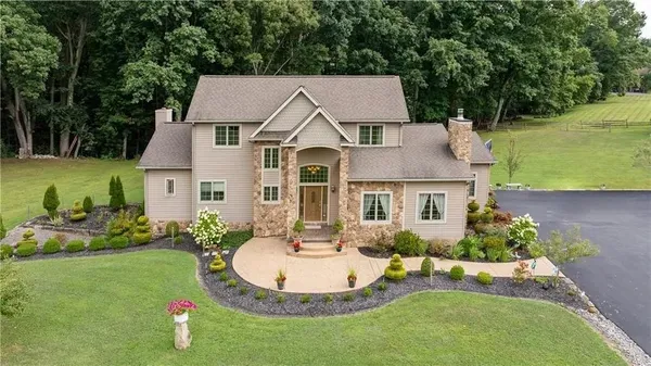 a aerial view of a house with swimming pool garden and patio
