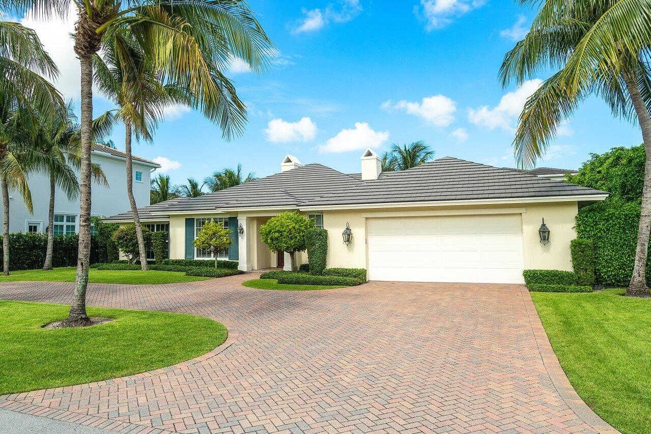 2377 East Silver Palm Road Boca Raton, FL 33432 - Photo 4 of 40 a front view of a house with a yard and palm trees